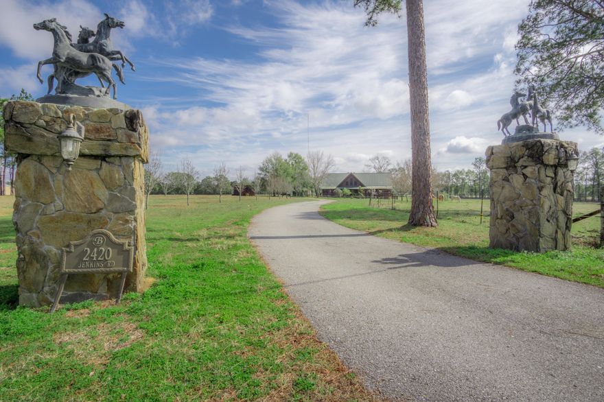 This stunning, authentic log home is an entertainer's dream, boasting an expansive great room with 29 ft cypress beamed ceilings, large bay windows, maple hardwood flooring, stone fireplace and an elevated dining area just off the kitchen perfect for large family gatherings. Inside the spacious master suite you will find 23 foot cathedral ceilings, his/hers walk in closets, dressing area and a large bath. The split floor plan allows privacy for the two additional bedrooms with en suite baths and a loft overlooking the kitchen/great room that could also serve as a fourth bedroom or bonus room. Outside features include multiple covered porches, attached carport, outdoor kitchen, storage building, brick paver driveway and much more. This home is located just outside the city limits on over 5.3 acres, close to Hwy 79 and Interstate 10.