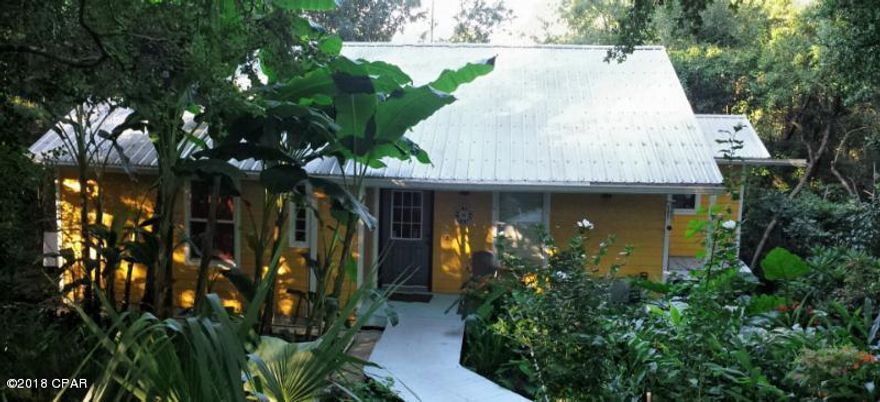 CURRENTLY UNDER CONTRACT, SELLER ACCEPTING BACKUP OFFERS. Walk along the boardwalk and into this custom built cottage style home with lush vegetation all around you. Vaulted ceilings welcomes you with large windows affording you a panoramic view of nature. Soak in the deep garden tub after a long day! The multilevel deck is perfect for entertaining or relaxing. Situated on two lots with direct waterfront on Lake Suzanne. Close to the recreation area with swimming pool, crystal-clear spring-fed lake, relaxing pool, tennis courts, basketball court, playground and lots of places to ride a bike! Only 35 minutes north of Panama City Beach and close to the airport and shopping as well. Fish for bass or brim or visit the many of the other lakes in the area. The property is 2 miles from water management which has hiking, fishing, deer and turkey hunting.