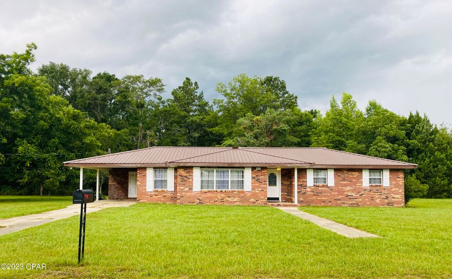 If you are looking for quiet country living but close to all the amenities then you've found it. This  beautiful brick ranch style home is centrally located and sits on almost an acre. This home features 3 bedrooms,2 bathrooms, and an extra room that can be used a a den. The living room has a wood burning fireplace for you to enjoy. The flooring in the living room,den and bedrooms have all been replaced with luxury vinyl planking. The primary bathroom has been completely redone and the home has been freshly painted. The kitchen offers ample counter space and plenty of cabinets and a double oven. It has a new metal roof and a newer A/C unit. 
Located on a cul de sac so you won't have to deal with any thru traffic and the Elementary school is right around the corner. It has a spacious block out shop with electricity in the backyard.  There are pecan trees,pear tree and muscadine vines that are fruit bearing located through the property. Enjoy your days outdoors in the comfort of your screened back patio and enjoy the serenity this home offers. Give me a call to schedule a showing. Come and see for yourself what this home has to offer!