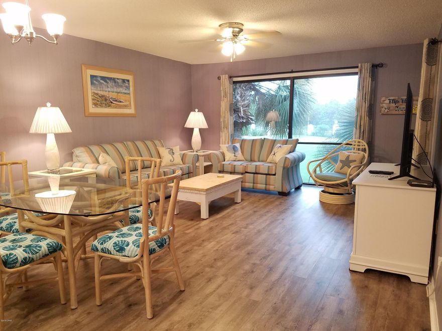 Beautiful fully furnished, second floor, one bedroom, two bathroom end unit. New vinyl plank flooring in living area.  Sliding glass doors in both the living room and bedroom opening onto a large balcony overlooking the par 3 Executive golf course. Large master bathroom with a large walk-in closet. Spacious full kitchen with stackable washer and dryer. Amenities include a tropical pool, gulf view restaurant, snack bar, a market serving Starbucks products, tennis courts, fitness area, shuffleboard, Salon and spa.  Gated entry, pets permitted for owners. Tram service available to beach and tropic pool area.