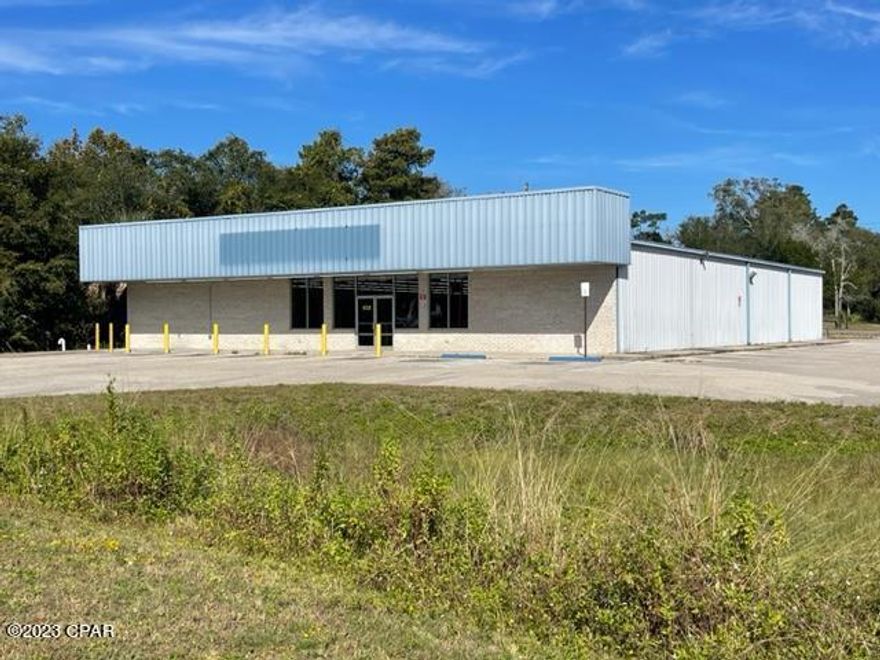 Located at the high traffic count area of US Highway 98 and Ave B in Eastern Carrabelle, Florida, this turn key 8000 square foot open plan commercial property gives one a variety options for just about any commercial endeavor. With the current state of construction prices and delays, one could potentially save hundreds of thousands of dollars and precious time by purchasing this property. Formerly a Dollar General, the current owner has painstakingly cleared and cleaned the building and grounds in order to provide the the new owner an opportunity to start their new business with a minimal amount of core renovation or additions. Building is comprised of double glass doors and plate glass windows in the front, open floor plan with drop ceilings, and multiple electric/technology outlets. There is an 11' 2'' wide series of rooms that runs along the entire western side of the building, accessed by a commercial steel door in the rear and houses mechanical/ electrical/ phone, as well as storage. Along the same perimeter are: women's bathroom, men's bathroom, office, and kitchen which are accessed from the front of the main building. Well designed parking plan that has been recently striped with 6 regular spaces & 2 handicapped spaces up front with an additional 22 spaces on the eastern side of the property. Overall site plan has a large entry off of US Highway 98, a rear entry off of Ave B, and a driveway off Ave A for ease of traffic flow as well as a easy rear access. Storm water pond with concrete flows as well as a large anchored sign pole situated strategically in the front of the property. 4 HVAC service the entire building and owner states generally 2 are all that is needed for general use. A must see and priced to sell!