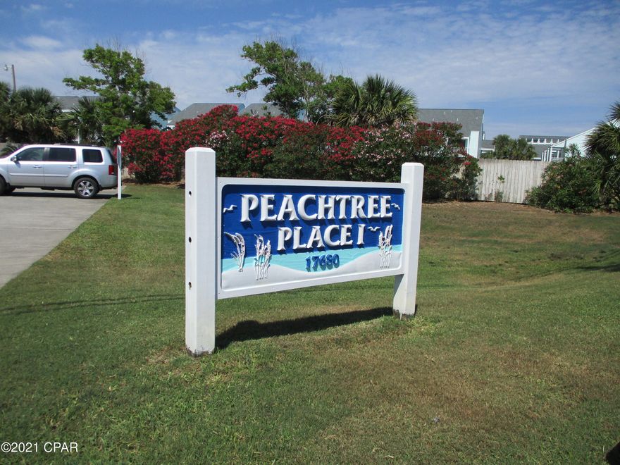 Walk to the beach - approximately 130 steps and you are looking at the crystal blue waters of Panama City Beach!  Enjoy this west end condo, cute as a button, well maintained, freshly painted, full size washer and dryer, sleeper sofa. and fully furnished!   Best of all - both bedroom doors open to an expansive wrap around balcony overlooking the pool, gulf peek and field of trees and bushes that can never be built on. - unusual privacy you cannot find at other condos!  Sit on the front porch rockers and enjoy a breeze while you take in gulf views.  This is a rare corner unit with more windows and more square feet. Peachtree Place is a low destiny condo complex with pool, grills, shuffleboard, basketball court, and directly across from your beach walkover.  Short term rentals allowed!