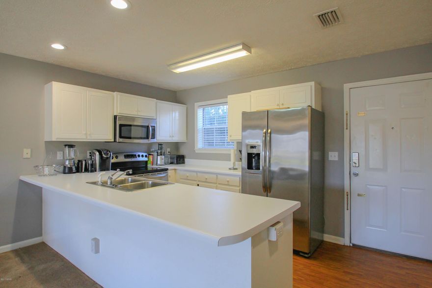No HOA fees on this partially renovated 2 Bed 1.5 Bath Townhouse in Panama City Beach. Recently upgraded with stainless Steel Appliances in Kitchen and includes a Washer and Dryer. Located conveniently between Front Beach and Back Beach Rd in a quiet cul-de-sac off of Allison Ave. Fenced-in Backyard. This home has a spacious open floorplan with oversized master bedroom with huge private balcony. Covered patio with separate storage area in the backyard. This home also qualifies for 100% financing with USDA. Perfect for a starter home or rental investment property. Don't miss out on this. BACK ON MARKET probably wont last long!!!