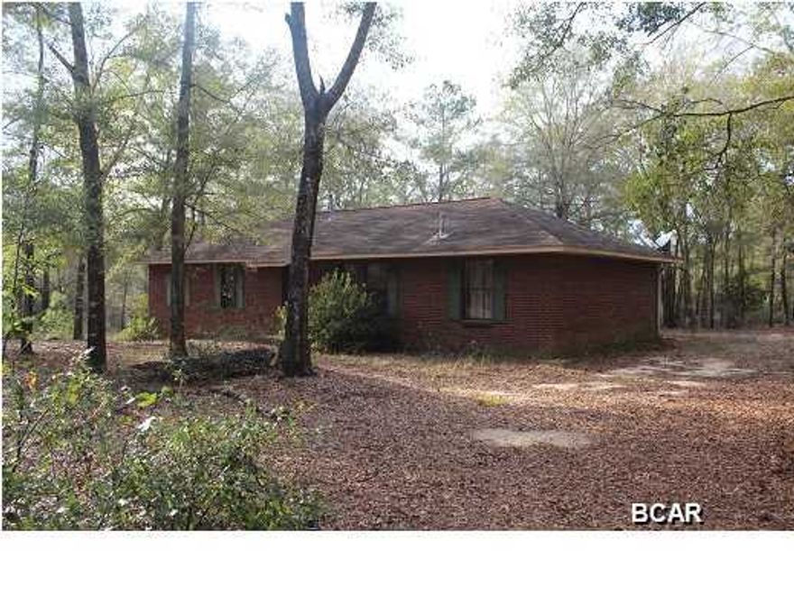 JUST REDUCED, DON'T MISS OUT ON THIS GREAT OPPORTUNITY! Ranch style brick home on 20 acres in Washington County. This property is located right beside the Sunny Hills subdivision which includes community lakes and golf course. This property is only approximately 25 miles from Lynn Haven. The lot is beautiful and full of trees. There is also an older mobile home that has been renovated behind the main house that would be a great mother-in-law house, guest house, or hobby building. This home would make a great homestead, weekend retreat or hunting camp. The property consists of two parcels 00000000-00-0938-0002 and 00000000-00-0938-0001. The neighbor says there is a small running stream to the back of the property, however I have not gone back there to confirm.
