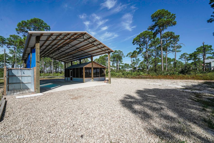 RV APPROVED LOT!! Welcome to a rare opportunity on Florida's Forgotten Coast-4934 SR 30A, Port St. Joe-a half-acre gem (approx. 100' wide) that's ideally situated & bursting with potential. This property is one of the few in this price range that sits outside the RV-restricted zone, giving you flexibility & freedom many parcels here don't offer. The lot already comes RV-ready with full utilities — water, sewer, electric (30 and 50 amp hook ups), phone & propane are all in place — plus a pole barn & a separate screened porch for shaded outdoor living. Whether you want to park your RV & enjoy it yourself, rent it out as an income property, or do both, the setup is ready to go. Centrally located, you're just minutes from the beach, a local boat launch & all the natural treasures that make this stretch of coastline so desirable. Behind your lot lies thousands of acres of the St. Joseph Bay Buffer Preserve, a sprawling protected area with miles of trails winding through coastal scrub, wetlands & natural habitat — your backyard leads straight into wild space. This property is zoned AE flood zone & is FEMA flood insurance eligible — a big plus in coastal property planning.  There's nothing holding you back from building your dream retreat here. Whether you envision a year-round home, vacation getaway, or investment build, this wide, deep parcel gives room to breathe — plenty of space to site your residence, yard, maybe a guest cottage or pool, while preserving privacy. With frontage on SR 30A, you'll have good access, yet you're tucked far enough in to enjoy serenity and nature. Picture stepping outside to morning light filtering through native pines, walking trails into preserved lands behind, and evening breezes with just a short ride to beach, bay, marsh, or small-town Port St. Joe. It's the kind of setting many dream about — and now you can own it.  Call for your private tour & LIVE THE BEACH LIFE!