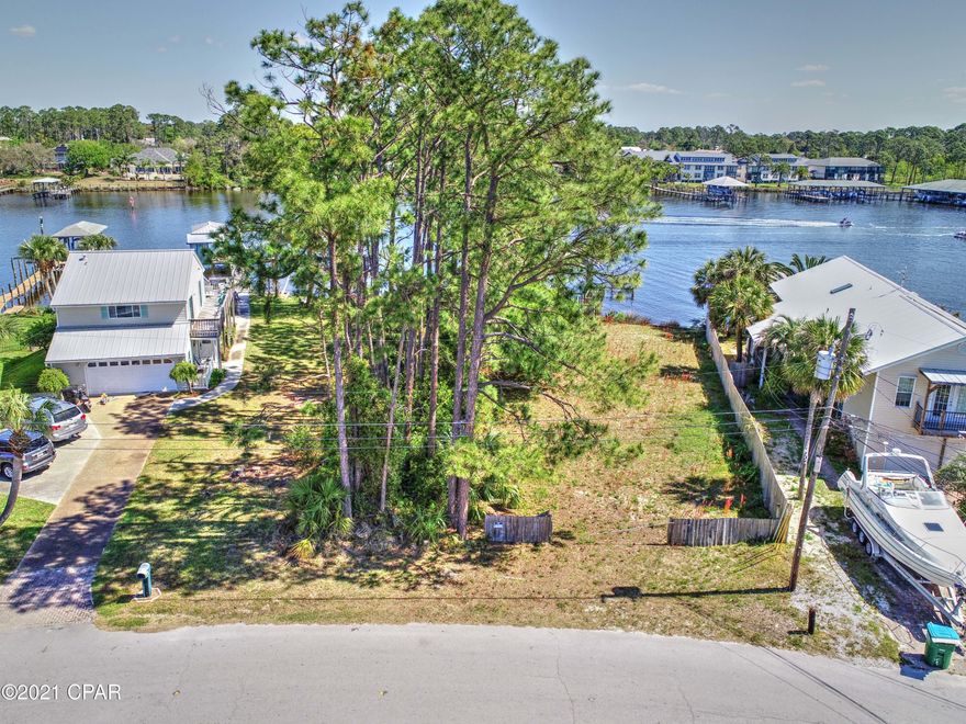 WATERFONT!  Over 60 Ft on Grand Lagoon and ready for your next home.  Build your dream property on the lagoon and enjoy life on the water in Panama City Beach!  There are not many waterfront lots left in this whole area, so it is a great opportunity to make this your new primary residence or your home away from home.   Perfect spot to keep your boat and enjoy your lagoon views.  You are in the best location and close to get out on the open water, close to grocery, shops, restaurants, St Andrews State Park, and the beautiful beaches of Panama City Beach!  Please note this lot is next to another vacant lot to the right side.  Your lot has wooded trees and also  part of the mowed land on left side - see link with survey.  Call today!