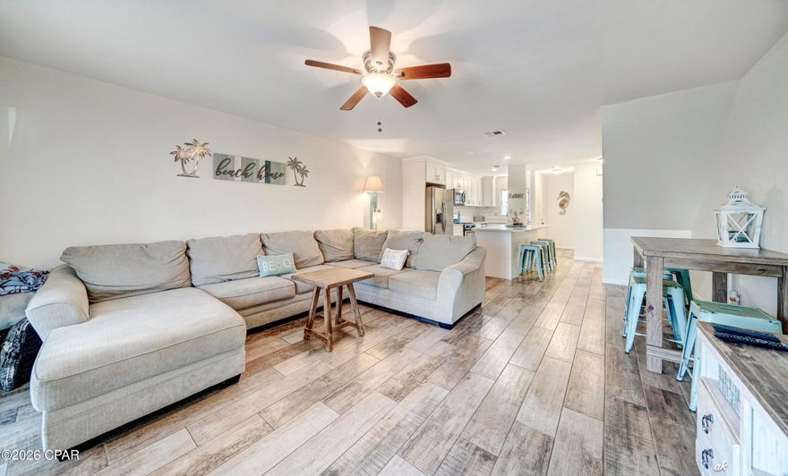 This updated home features the only open floor plan currently on the market in Beachwalk.  In 2018 it was beautifully and professionally updated with solid surface countertops, new cabinets, ceramic flooring downstairs, LVP throughout the rest of the home, new paint, tiled showers, sinks, toilets and more.  This home features 2 baths, but also has a separate vanity/sink off the master. SHORT TERM RENTALS ARE ALLOWED.  TASTEFULLY FURNISHED and equipped with WIFI thermostat and electronic door lock, makes this property turnkey, while managing the property yourself a breeze, if using it as a rental.  It has been primarily used as a second residence and is in EXCELLENT CONDITION.  This is one of the few homes in the quiet neighborhood of Beachwalk with the main entrance positioned thru the living area versus kitchen/bath hallway. Conveniently located steps from the pool or a short 7 minute walk to the beach enables you to enjoy the beautiful Florida weather with ease.  New roof in 2025 and newer appliances alleviates the worry of those expenses. THIS HOME IS MOVE IN READY and, while more updated than the other homes on the market, it is also competitively priced!  Book your showing today!