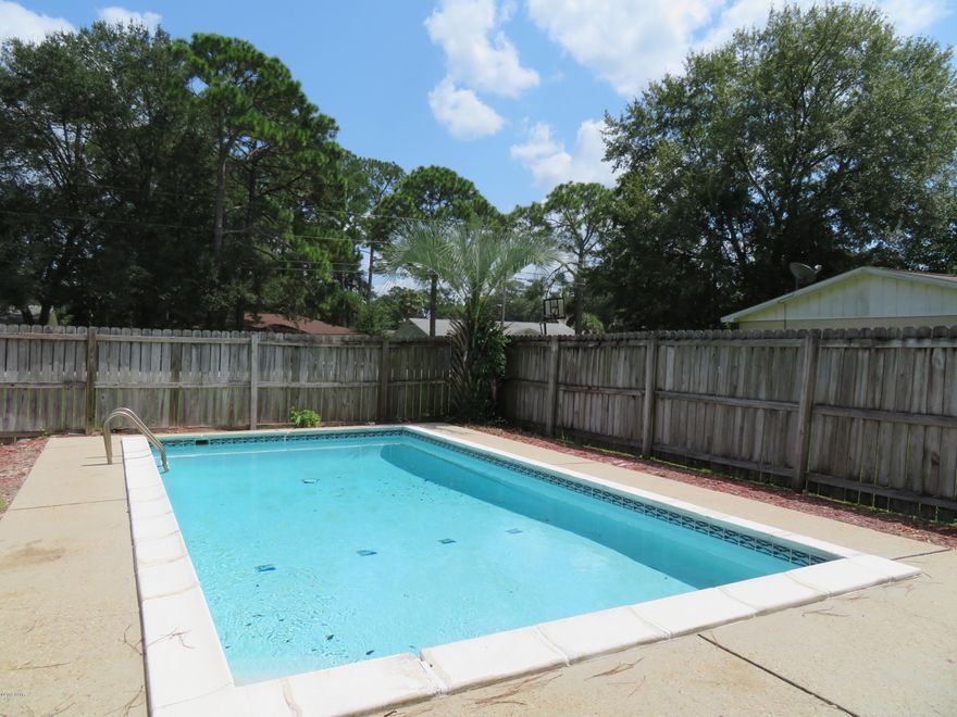 Ready for Move-in!  Don't overlook this solid 3/2 block home with in-ground POOL on a 3/4 ACRE corner lot in Callaway! This  spacious home has been updated with easy care tile & bamboo flooring, new windows and updated master bath. New roof in 2014, new gas heat in 2012. The large eat-in kitchen is the energy hub of this home and needs comings and goings of a new family. Adjoining is a formal dining room with built-in hutch. Large living room with built-in cabinets.  All bedrooms feature bamboo look wood flooring. From the kitchen you have access to the inside laundry room and an adjoining den with view of the POOL.  Relax on the screened back porch and smile while you survey your own little kingdom. The adjoining lot with storage building and covered parking spot is included in the sale