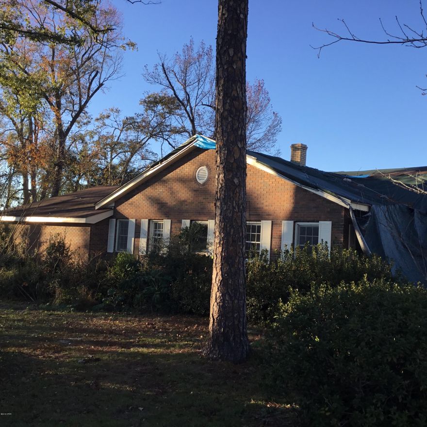 Big house in town on large lot.Has 4 bedrooms and 3 baths.Home needs work.Roof was heavily damaged  from hurricane Michael. Has been trapped , but has been exposed to the elements.Repairs/ complete remodel has been estimated at 75,000.Home has a basement too. This home could make someone a very nice BIG home.