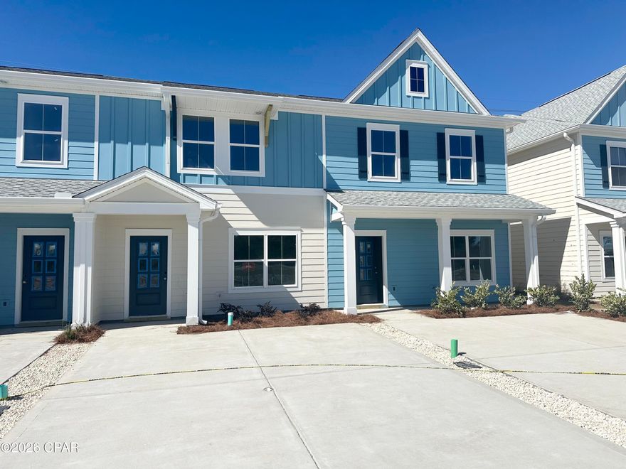 NO RENTAL RESTRICTIONS!!! Check out the open green space behind this townhome!!! Waypoint by Traton Homes, a vibrant new community of townhomes located on Front Beach Road in Panama City Beach, Florida. Waypoint offers 72 homes just under 3 miles from the beach, 1.5 miles from Dolphin Bay, and approximately 20 miles from the Northwest Florida Beaches International Airport. Residents will enjoy easy access to local attractions, with Pier Park only 7 miles away and Hathaway Bridge nearby, serving as the gateway to Panama City proper. The community is also conveniently situated near the Naval and Coast Guard bases.  Each townhome features 3 or 4 bedrooms, including a bedroom with a full bath on the main level. The open concept living space includes a modern kitchen with an island, a dining area, and a family room that opens to a private back patio. Upstairs, the spacious owner's suite offers a walk-in closet, and an ensuite bath with a double vanity, a shower, and a separate water closet. Two additional bedrooms, an additional full bath, and a conveniently located laundry room complete the upper level.