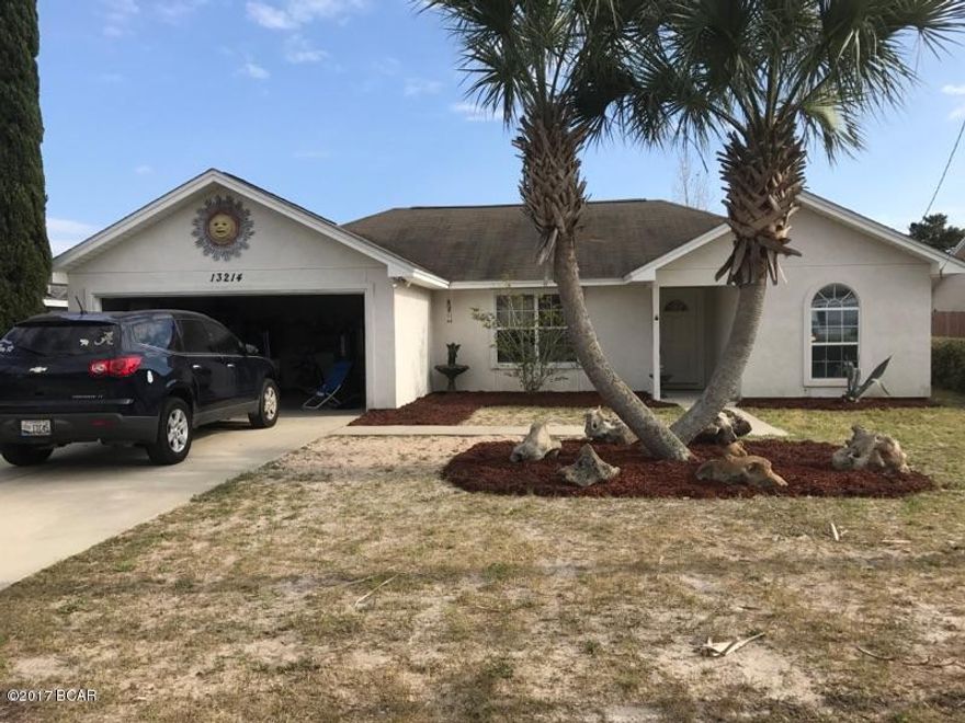 Great home right in the center of Panama City Beach with easy access to and from the neighborhood from Back Beach or Middle Beach Road. Just minutes from all the shopping and great restaurants at Pier Park.  Enter from the covered front porch into the foyer and great room that really opens up with high cathedral ceilings and overlooking the kitchen and dining area.  Appliances and built in microwave plus custom stone backsplash adorn the kitchen. Split bedroom plan. Nice master suite with private bath and tile floors. Plenty of closets and storage. Home has been under a termite bond with Florida Pest Control since built. Privacy fenced backyard with large open patio. Check out this affordable well priced home in a great location.