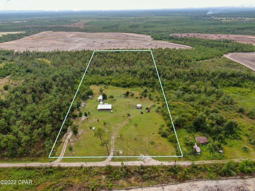 Large 10 acre property located close to major cities but still far enough away for peaceful living. The Front half of the property has been cleared. 4 sheds are included with the property. Large wrap around front porch to enjoy the outdoors. Well and septic for low cost of living. Come build or bring you dream home today! This is your opportunity to home stead on an amazing piece of property!