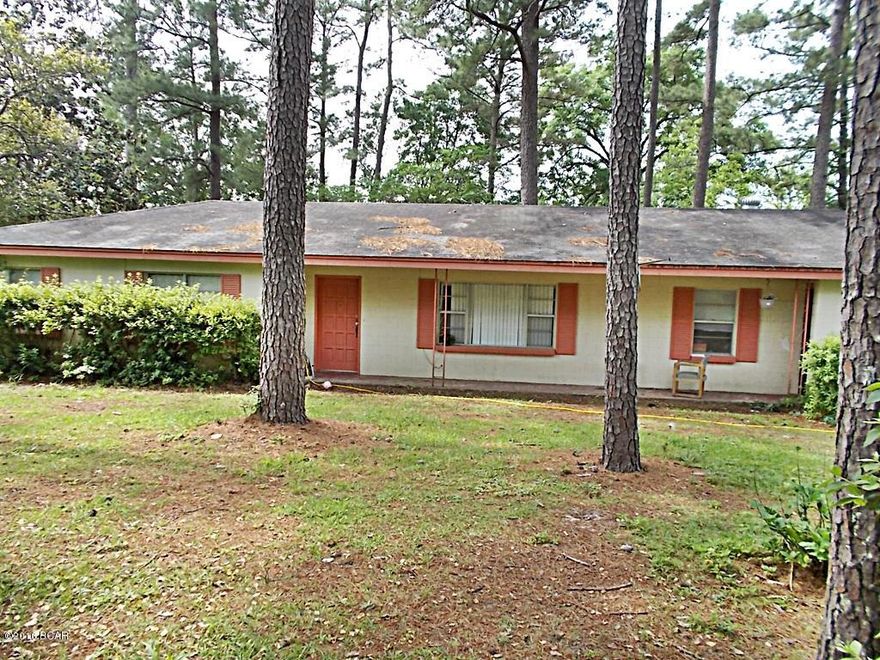 Solid block home in city limits with city water and sewer, large front and back yard with chain link fencing, lots of native trees in the yard, large family room with old wood heater, open kitchen and dining room with plenty of cabinets, bonus room on back for another bedroom or a sitting or office, large laundry room,carport and an  additional double carport and workshop  in yard. All walking distance from many shops and post office. Call agent to view, tenant occupied.