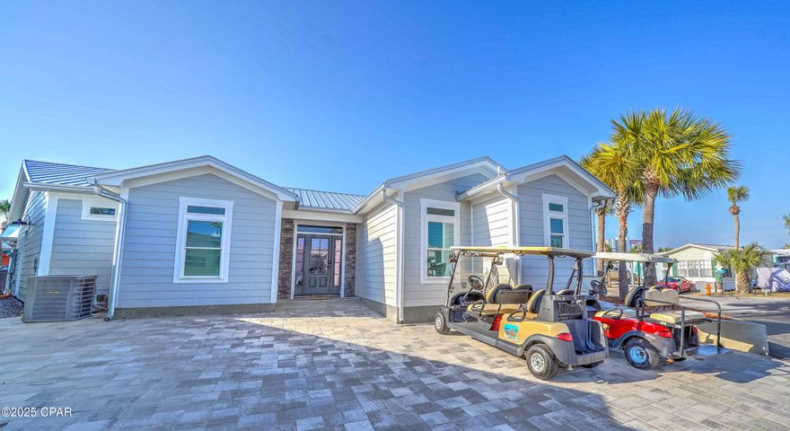 Modern paradise found here in this newly constructed home on a large corner lot!  This rental powerhouse is nestled within the popular resort of Venture Out.  This stunning 3 bedroom, 3 bath home was built in 2024 and is located on one of the largest lots within the resort.  Home has Hardi siding, vinyl plank flooring, quartz countertops, stainless appliances, beautiful pavers and much more. This great home also has 2 nice outdoor areas, that create plenty of room for grilling and relaxing after a long day at the beach.  Home is being sold furnished with rentals stacked on the books for 2025. Make this your 2nd home or become a local and join us in paradise living your best life here in Venture Out!   It doesn't get better than this! Venture Out is a golf cart community that has exploded with popularity recently... With 300' on the beautiful pristine beaches of the Gulf of Mexico and 1,000' on the Grand Lagoon. Venture Out has something for everyone. With 2 pools, fishing pier, boat ramp, mini golf, & more