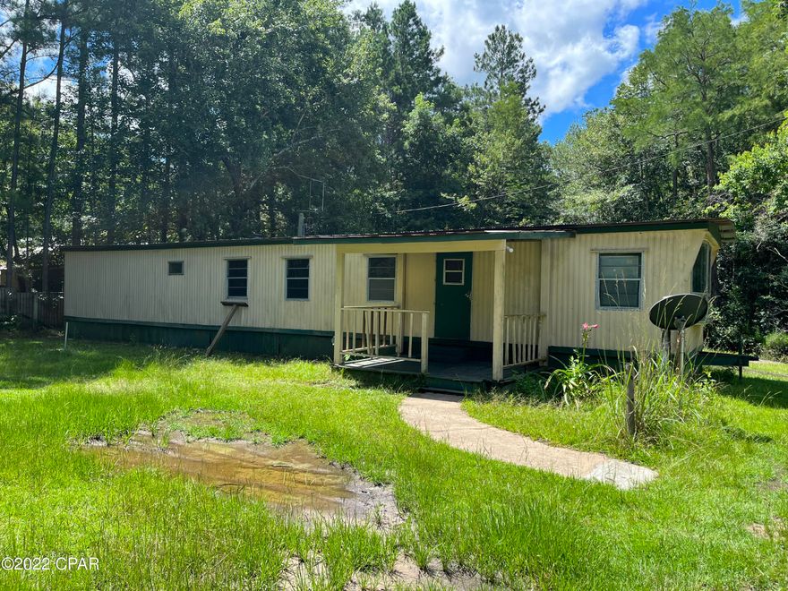 CURRENTLY UNDER CONTRACT, SELLER WILL CONSIDER BACKUP OFFER. Beautiful corner lot within the city of Vernon, featuring city water and sewage, a pond, and an older single-wide mobile home. This lot is a short half-hour drive from the beaches, shopping, restaurants, and more offered by Panama City Beach. If you want to be close to the beaches but prefer to live in the country, this property is perfect!