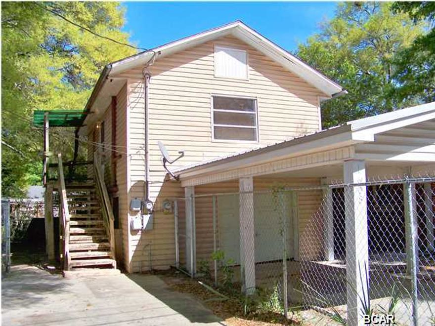 A must see investment property located in the heart of historical St. Andrews. Situated on a large, fenced, corner lot within walking distance of Oakland Terrace Park and Lake Caroline and St Andrew Marina. Just a short drive away, you will find the Bay County Library and Bay County Government Center, as well as shopping and dining and entertainment. The property has a 3 bedroom, 1 bath unit downstairs with a 1 bedroom/1 bath unit upstairs. Both units have living/dining combo and kitchen. The upstairs unit has an open deck, while the downstairs unit enjoys an enclosed Florida Room. Shared laundry off the garage which has lots of storage. In addition, there is also covered parking on the driveway. Each unit has a separate fenced yard. Live in one and rent the other or rent both.