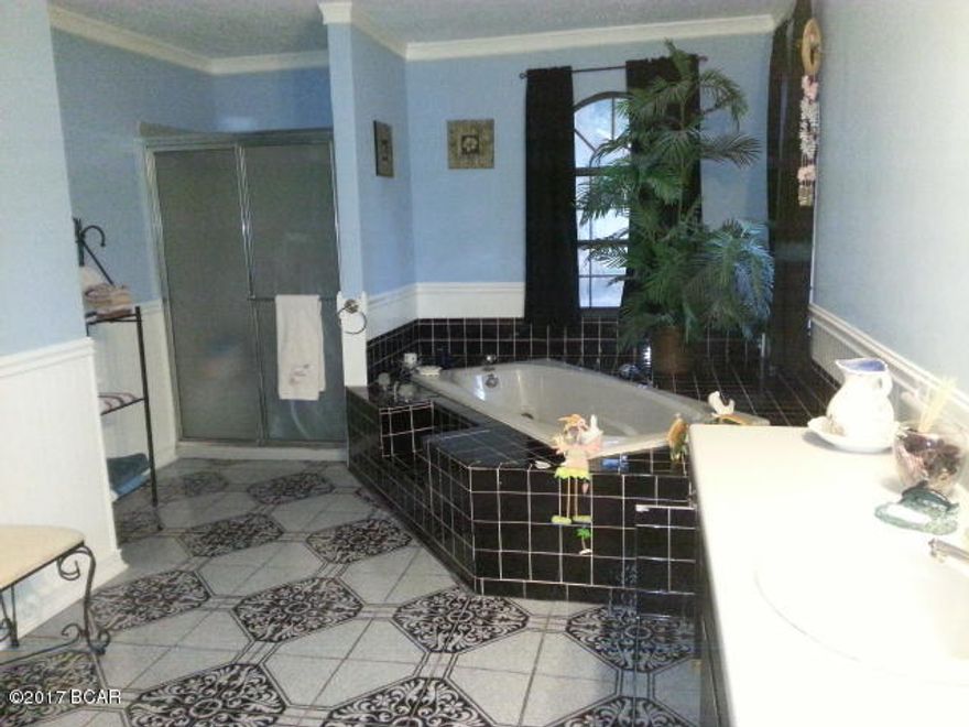 Beautiful home convenient to shopping, schools, and Tyndall AFB. The kitchen features stainless steel appliances, lots of cabinet space and yes there is a pantry! The living area opens up to the dining room. Three of the bedrooms are split from the master and they all share a full bath. HUGE master suite with wood burning fireplace and bathroom that features a whirpool tub and stand alone shower. There is a shed in the back yard and a well for irrigation.