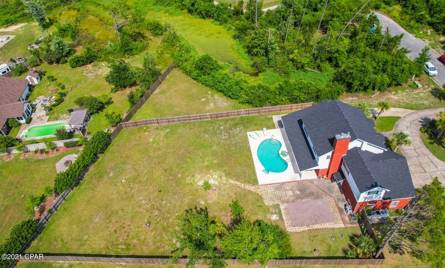 CURRENTLY UNDER CONTRACT, SELLER ACCEPTING BACK UP OFFERS! This beautiful home is tucked at the end of a well manicured street in Mill Bayou, one of the most desired subdivisions in Bay County. This spacious home has plenty of rooms for the family to hang out all together or to find their own nook to relax. There is an open kitchen and family room that includes a beautiful fireplace. Another living area is downstairs as well as an office with custom shelves and french doors. The master bath has a separate spa tub/shower and walk in closet.  There are three additional bedrooms  and a bonus area that could be a game room or teen dream closet! Relax by the pool and enjoy the huge backyard or walk over to the nearby golf course. Check out the virtual tour.