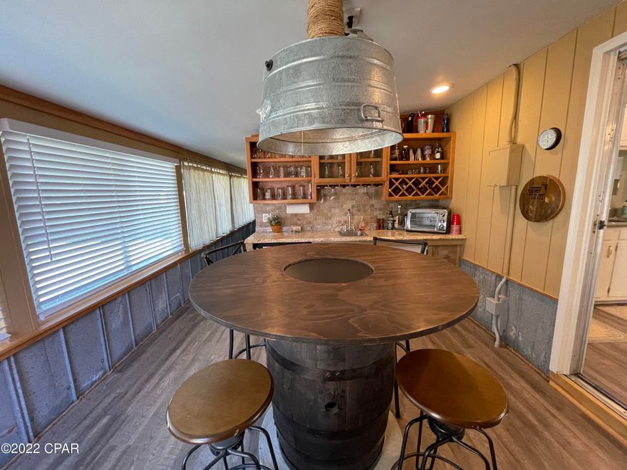 Fully Furnished 3 BR, 2.5 BA home for lease west of Pier Park on Panama City Beach. Many recent updates include making an open concept from the kitchen to the living room with new quartz counter tops, new vinyl plank flooring and a wet bar room with bar table. The home has 3 bedrooms, an office w/ barn door, 2 full bathrooms and half bath w/ a shower/vanity in the bonus Florida room. The kitchen is very spacious and has a refrigerator, stove/oven, dishwasher, microwave. The master bedroom features all new bedroom suite and has an en suite bathroom fully remodeled. The master sits right next to the bonus Florida room with a sliding door access. The two additional bedrooms have queen beds and a shared hallway bathroom recently updated. Inside laundry with washer/dryer included; Covered carport, large fenced back yard with fire pit and workshop. Rent includes lawn service and trash. *Pets negotiable with $250 non-refundable pet fee.