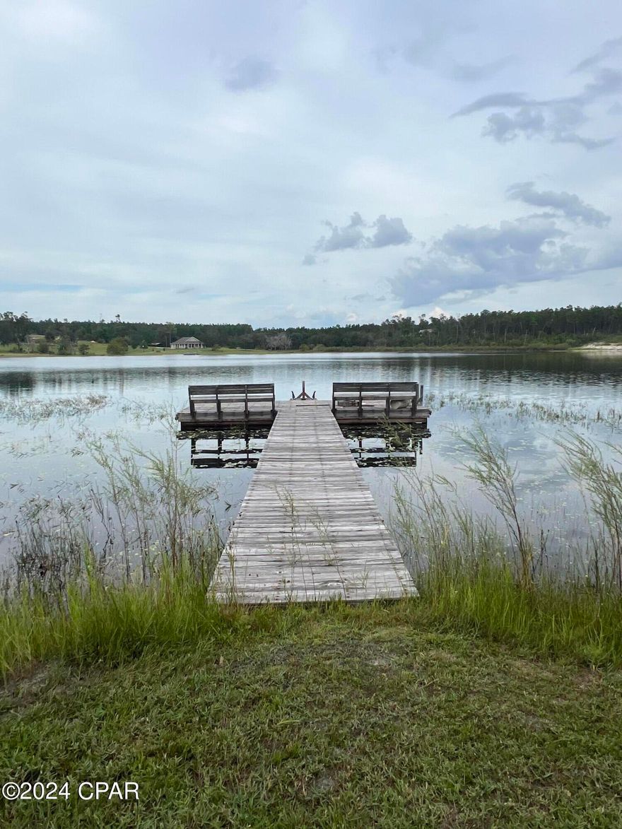 Stunning lakefront acreage, nestled within a prestigious gated community. This rare gem offers breathtaking views of a pristine, spring-fed lake, perfect for fishing, swimming, all water sports or simply relaxing by the water's edge. This lake is a private lake accessed only by property owners. This is an ideal site for building a home in a very safe and secure gated community. Plans to pave the road are in place for near future. Located just a few short minutes from Lynn Haven and the World's Most Beautiful Beaches, PCB. Don't miss the chance to own your own piece of paradise, call today.