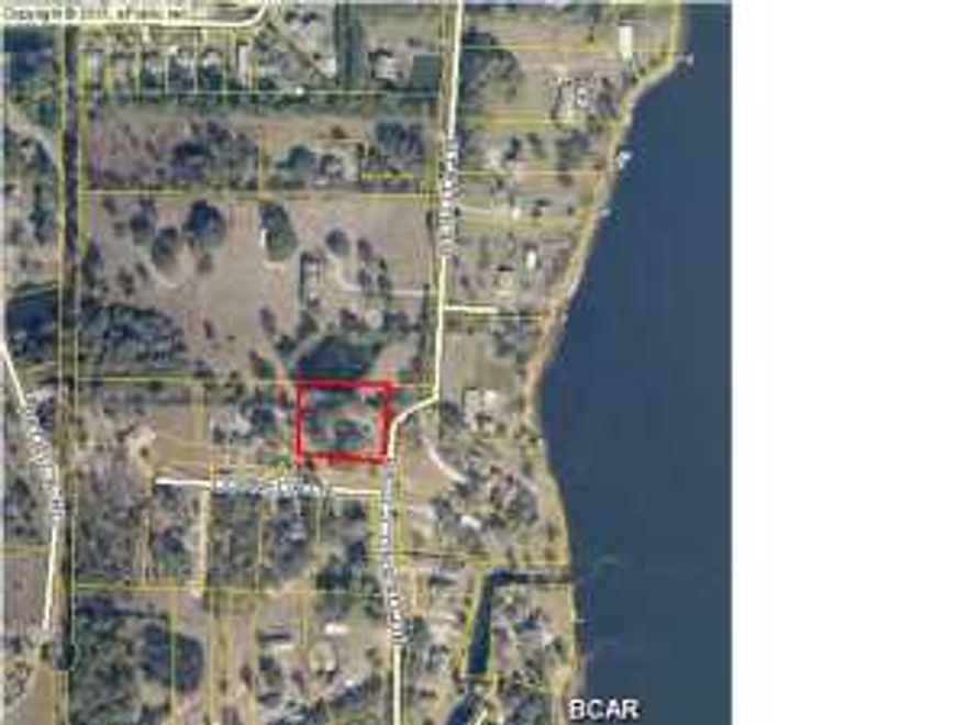 Beautiful building lot in subdivision with underground utilities. Mature Oak trees on perimeter of lot make for a picturesque setting for a home. Deer Point lake is across the street and public access for boats is easy. Small pond backs up to lot in rear, but does not encroach.
