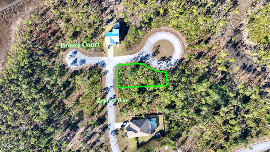 A Corner lot in a beautiful gated community with Bay views! This spacious lot in Laird Point offers ample room for a large home, back yard, pool, storage and more. It's located across the street from St Andrews Bay with stunning views of the sunset. This community has paved roads, tennis/pickleball courts, and storage for your boat or RV. Laird Point features unmatched nature and peace with tall pines and quiet atmosphere. You get all of this while only being a short drive to shopping in Callaway and Tyndall Air Force Base. Underground utilities with city water and sewer available.