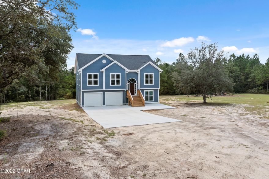 Exquisite! Impeccable!  These are a few words that describe this 4 bedroom, 3 bath recently constructed home! Step inside this split level and you are immediately greeted with a beautiful oak staircase and an abundance of natural lighting. Upstairs you will find a spacious living room open to the dining/kitchen boasting an island with breakfast bar, granite countertops, pantry, stainless-steel appliances, and French doors that lead out to the 10x22 covered porch. A master bedroom with ensuite bath, 2 guest rooms and full bath complete the top floor. The lower level would make the perfect place for guest as it features a dining/family room with kitchenette, bedroom with full bath, laundry, and screened porch. Other features include dual zoned heating and cooling, attached 2 car garage and Hardie siding. Enjoy your days outdoors riding trails on your ATV, shooting from your personal rifle range or hunting in the duck blind. Home is located on a stunning 25+/- acres minutes to Interstate 10 and approximately a 45-minute drive to the "World's most beautiful beaches".