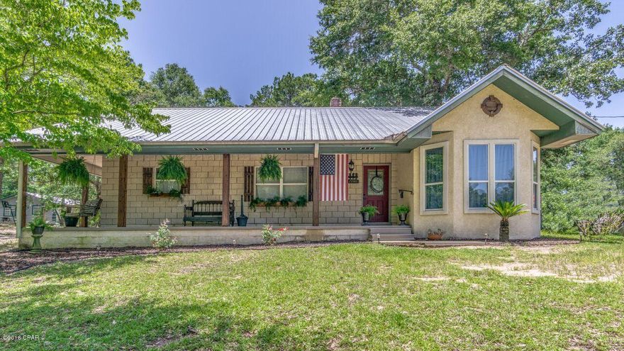 OPEN HOUSE SAT AND SUN, AUG. 11th and 12th FROM 12-4!!  This home is the epitome of country living. 3 bedrooms with a bonus room that has its own exit. The exterior boasts a porch that wraps around the front of the home,and brand new shutters across the front with  matching posts, and porch swing! The interior has been done in farmhouse chic with a touch of whimsy...spacious living area with vaulted ceilings and stone fireplace. New interior paint, wainscoting, and barnwood tile floors throughout. This home has had a new Metal roof, a new AC, and all new black stainless steel appliances installed in 2017. The Whirlpool Cabrio washer and dryer convey with the home. Large Kitchen and dining area. Enclosed Patio off the living area with barnwood tile floors to match the interior, as well as the addition of the back porch and gravel bed. Out back, beyond the back yard, you have a fenced in area with a barn(with loft) for horses....the barn also has water run to it. Cement block and stucco construction with 1854 square feet situated on a high and dry acre of land in between Pine Log lake and Sweetwater Lake. Close to Boat Lake in Sunny Hills, and Holmes Creek. 30 minutes from Lynn Haven, 40 minutes from Panama City, and 40 minutes from Panama City Beach.  The only thing this house is missing IS YOU!   Schedule an appointment with your Realtor today! All measurements are approximate- if important, please measure and verify.