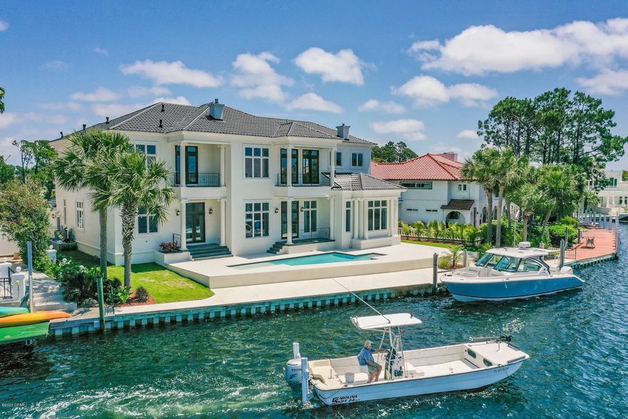 Rarely do site and structure so perfectly align to evoke a lasting sense of wonder. At 106-ft of DEEP-WATER frontage sits an achievement in American modern design that blends exquisite finishes and awe-inspiring panoramas to pique curiosity at every turn. Upon crossing the home's threshold, the Grand Lagoon appears within arm's reach, as its waters gracefully extend to the backyard dock and pool. Thoughtful design elements are evident throughout the home including a driveway fit for low-suspension vehicles leading to a 3 car garage, modern chef's kitchen with waterfall absolute black honed granite center island, butler's pantry and incredible features that include indoor-outdoor living, panoramic views from virtually every space. A cocktail pool measuring ~36x14 feet. Marble of various depths and color adorn the estate's main floors, with stunning contrasting black wood floors in the master and second level. Upstairs, a second master with balcony, game area, additional bedroom and two more guest suites boasting sitting areas, balcony, and custom closets. 262 Marlin Circle is poised within Bay Point as one of the shortest boat rides to St Andrews Bay and the Gulf of Mexico. With every amenity imaginable and a location at the center of fine dining, yachting and golf, all within the guarded community of Bay Point, there is no better place to escape the mundane.

All measurements are approximate, please verify if important.