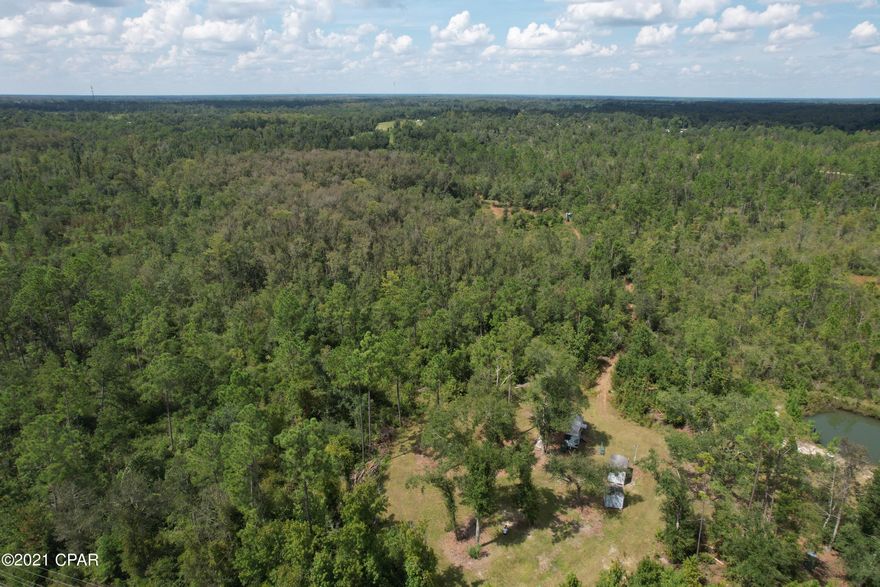 Very nice wooded parcel on Hwy 90 in Grand Ridge, this  would be an ideal homesite, the previous owner used it for a hunting retreat. There are deer stands, food plots, a shed, a closed in container/Pod he used for a camp. There is a small fish pond, a power pole to the property, deer feeders, ATV shed, and  hunting blinds on the property. There  are trails and a road cut through the property, Please do not go onto property without your agent. The owner is not responsible for any accident or personal injury for anyone on the property at any time.