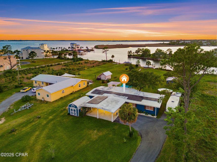 Waterfront living meets peace of mind in this rare solid block construction home featuring a brand new private dock, boat ramp, deep water access, and a solar system to be paid in full at closing. Offering the space, waterfront access, and major upgrades buyers expect from higher-priced coastal properties, this move-in ready home delivers exceptional value without compromise.



Built to last and designed for true waterfront living, this property proved its durability as the only home on the street to withstand Hurricane Michael--even nearby million-dollar stilt homes just a few doors down required extensive repairs, while this home needed none.



Enjoy direct boating access from your brand new private dock and boat ramp, making fishing, boating, and sunset cruises part of everyday life.



The large lot provides plenty of room to spread out and includes two oversized powered storage sheds/workshops, ideal for hobbies, equipment, storage, or workspace.

Major improvements have already been completed, including new windows, HVAC system, driveway, and a solar system that will be paid off by seller at closing, allowing future owners to enjoy energy savings without assuming a solar loan. Connected to city water and sewer for added convenience.

A standout feature is the elevated concrete carport/breezeway that stays dry and doubles as a shaded outdoor living area, complete with double entry doors that create an open-air space perfect for relaxing and enjoying summer breezes.

This is a unique opportunity to own a well-built, upgraded waterfront property offering both functionality and lifestyle.