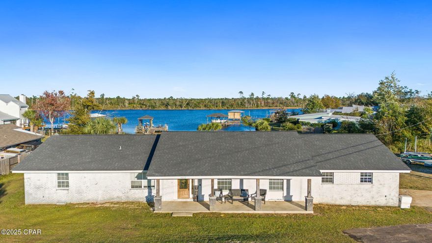 BRING ALL OFFERS! Looking for a diamond in the rough? Look no further. Welcome to your own slice of Southern coastal paradise—an inviting waterfront home set on over an acre of land with 2100+ sqft of heated and cooled living space. Perfectly positioned on tranquil Mill Bayou, this property offers easy access to both inshore and offshore fishing as well as easy boating trips to the pristine shores of Shell Island.

Outdoors, the property is designed for the sophisticated sportsman and relaxation-seeker alike. A private pond provides the ideal spot for stocking your own private brood, while the private dock—complete with electricity, freshwater, an oversized deck, and a 10,000 lb boat lift—makes sunrise watching, afternoon fishing, and weekend boating effortless.

The back of the home is made for year-round enjoyment. A sprawling open deck spans the width of the house, featuring a natural gas fire pit on one side of the sunroom and a fully equipped natural gas outdoor kitchen on the other. Whether you're hosting friends or savoring peaceful evenings by the water, this space was built to be enjoyed. A well-designed garage accommodates one vehicle and a golf cart, and includes multiple storage areas, both climate-controlled and non-climate-controlled, plus a dedicated tool shed space.

Inside, this 3-bedroom + office, 2.5-bath home offers an open and airy floor plan ideal for entertaining when the weather keeps you indoors. The spacious kitchen showcases updated shaker cabinets, granite countertops, and a generous island with a wet bar. A large living room and dining area flow comfortably together, with a convenient laundry room and oversized butler's pantry just off the kitchen and garage entry. The office sits just off the dining room, providing a quiet, flexible workspace. Down the hall, you'll find two well-appointed guest bedrooms, one with direct access to the back deck. The expansive primary suite, once two separate bedrooms, has been combined to create a luxurious retreat with an impressive walk-in closet. The updated primary bath includes double vanities, a beautifully tiled walk-in shower, a relaxing soaking tub, and abundant storage.

With a few minor repairs, fresh paint, and flooring updates, this waterfront home will shine like a diamond. Call your Realtor TODAY to learn more or schedule your private showing of this exceptional Mill Bayou property.