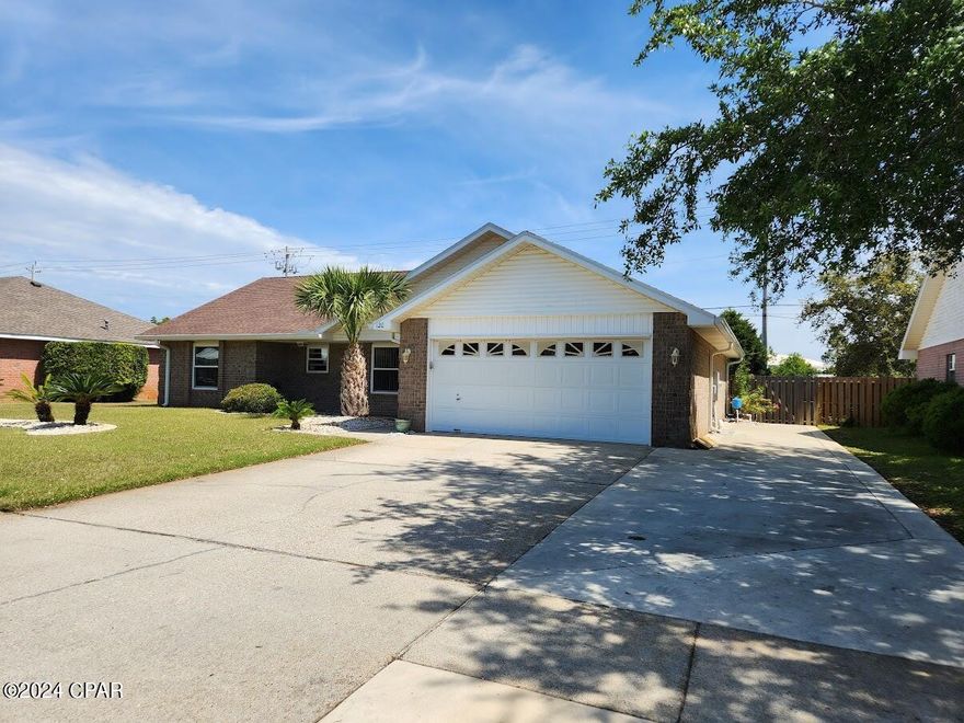 CURRENTLY UNDER CONTRACT, SELLER WILL CONSIDER BACKUP OFFERS.  Make your dreams come true with this all brick split bedroom home that is conveniently located less than a half of a mile from the beautiful beaches of the Emerald Coast.  The home features new windows (23), granite countertops, carpet(23), fireplace, well water for lawn sprinklers, oversized driveway, 2024 a/c, 2022 hot water heater and 2022 appliances. The oversized backyard has a shed for your toys and lawn equipment as well as a covered lanai perfect for days and evenings of relaxation. Enjoy the sunsets with a quick golf cart ride to beach access 52 which is located within walking distance to Pier Park, restaurants, and entertainment. The community pool and picnic area within a quick sidewalk stroll is waiting for you.  Schedule your showing today.  Age, Sq.Ft., Dimensions, Schools, Tax, or any important information is just an estimate and must be verified by the buyer via professional or personal inspection.