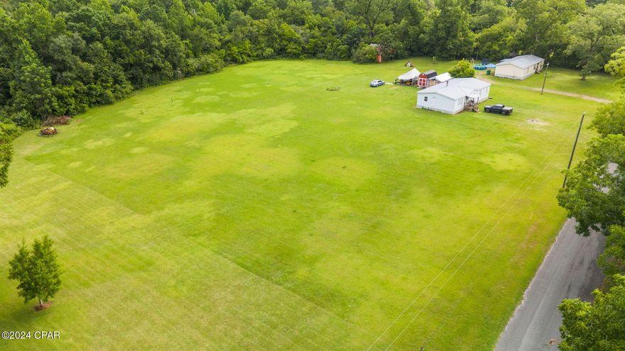 UNDER CONTRACT - SELLER WILL CONSIDER BACK-UP OFFERS - Discover the perfect location for your future homesite on this beautiful .77-acre cleared lot in the charming city of Graceville,where a variance to allow manufactured homes has just been approved.   This spacious lot has been surveyed and is conveniently situated on a paved road, offering easy access to the downtown area and all its essential amenities. Enjoy the convenience of public water, sewer, and electric access, making the building process smooth and efficient. Located in a peaceful neighborhood, yet just moments away from downtown Graceville, where you can find shops and restaurants. With .77 acres of cleared land, there's plenty of room to design and build the home you've always envisioned, along with additional outdoor space for gardens, play areas, or recreational activities.  The adjacent lot is also available for sale providing even more room to expand or put an additional home on.  Don't miss out on this rare opportunity to create a custom home in a welcoming community. Contact your favorite realtor today for more information and to schedule a visit to see this fantastic lot for yourself!