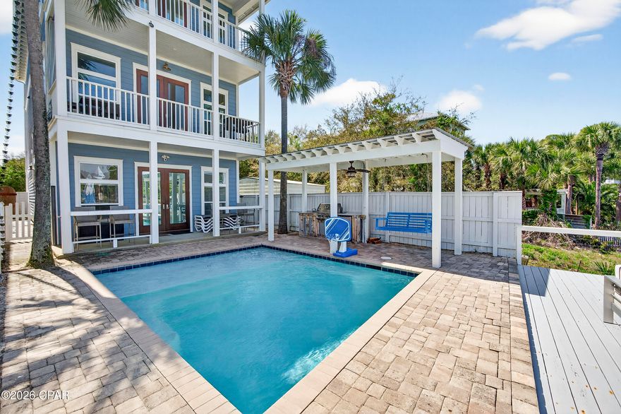 Where boating days meet barefoot beach mornings - this custom-built waterfront home on Grand Lagoon captures the best of Panama City Beach living. Positioned as an end residence with no neighbor to the west, it offers added privacy in a quiet, golf cart-friendly neighborhood where you can step onto your private dock or be on the sand in under 5 minutes via Public Beach Access #21. From here, it's an easy ride or walk to nearby shopping, dining and entertainment including local favorites like Schooners and Harpoon Harry's, giving you a lifestyle that's both relaxed and connected.

Spanning three levels, this 4BR/4BA residence blends upscale craftsmanship with thoughtful functionality. Brazilian cherry flooring and mahogany doors are complemented by granite countertops and custom cabinetry throughout, while 10-foot ceilings and 8-foot doors create a warm, refined aesthetic. Expansive living spaces and multiple balconies maximize views over the Gulf and Grand Lagoon. A hydraulic elevator services every floor, adding a level of everyday convenience that's hard to overstate - whether bringing in groceries or making multi-level living more accessible and effortless.

Two separate living areas offer flexibility to spread out and unwind, creating distinct spaces for relaxing or hosting. The designer kitchen is built to gather, featuring top-of-the-line appliances and an open layout that flows seamlessly into the living area and oversized balcony overlooking the water. The primary suite opens to a private waterfront balcony and features a spa-inspired bath with a frameless glass steam shower and jacuzzi tub. Each additional bedroom offers its own private balcony and a bath with a jacuzzi tub, while a top-floor guest suite lives like a second primary.

Outside, the Florida lifestyle takes center stage. The heated saltwater pool with sun shelf, bubblers, and umbrella ledge invites long afternoons in the sun, while the covered lanai and outdoor kitchen create the perfect setting for gathering. The private dock with remote-controlled boat lift (accommodating approximately up to a 10' beam and 30' vessel) includes shore power, water, and cable - putting Shell Island, St. Andrews Bay, and the Gulf just a short 15-minute ride away. Spend your days fishing, dolphin watching, or anchoring out for a beach day with the family.

Additional highlights include two laundry rooms (first and third floors), a whole-house Generac generator (2021) for added peace of mind, hurricane-rated windows and doors, smart home features (Ring cameras, connected locks and lighting), a new paver driveway (2022), and a one-car garage.

Offered fully furnished with high-quality, homeowner-grade pieces (with just a few minor personal exclusions; golf cart and fishing equipment negotiable), this home is move-in or rental ready. It has not been used as a rental by current or previous owners, offering a well-maintained, lightly used opportunity.


If you're looking for a waterfront home that feels tucked away yet keeps you close to the beach, dining, and everything Panama City Beach has to offer, this one delivers. Schedule your private showing to see it firsthand.
