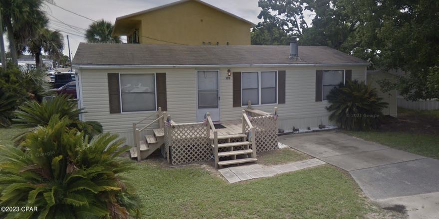 This corner lot, 3 bedroom, 2 bathroom double-wide trailer is 2 blocks to the white sandy beaches. Lot size is 50x65.