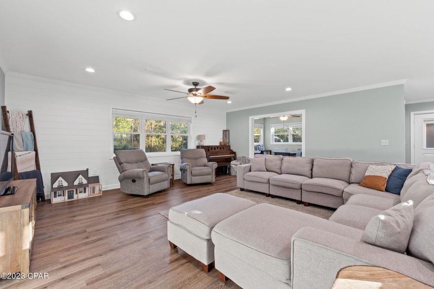 Discover the perfect fusion of country living and contemporary luxury on this 4-acre, fully renovated property. Tucked away in a serene wooded landscape, this home has undergone a comprehensive overhaul in 2021, featuring shiplap accented walls, crown molding, and recessed lighting that add elegant touches throughout.  The property offers a new metal roof, septic system to include capability for future bathrooms, electrical and plumbing updates, luxury vinyl plank flooring in common areas with carpeted bedrooms for added comfort, black stainless appliances, windows, and doors. The home also features a tankless hot water heater and keyless locks for modern comfort and security. As a bonus, the property has been surveyed, ensuring boundaries and providing peace of mind.  An attached garage with a covered breezeway adds convenience, and the paved road frontage ensures easy access. With a spacious backyard for your imagination to roam and the charm of country living just minutes from town, this home is a unique opportunity for a balanced lifestyle.