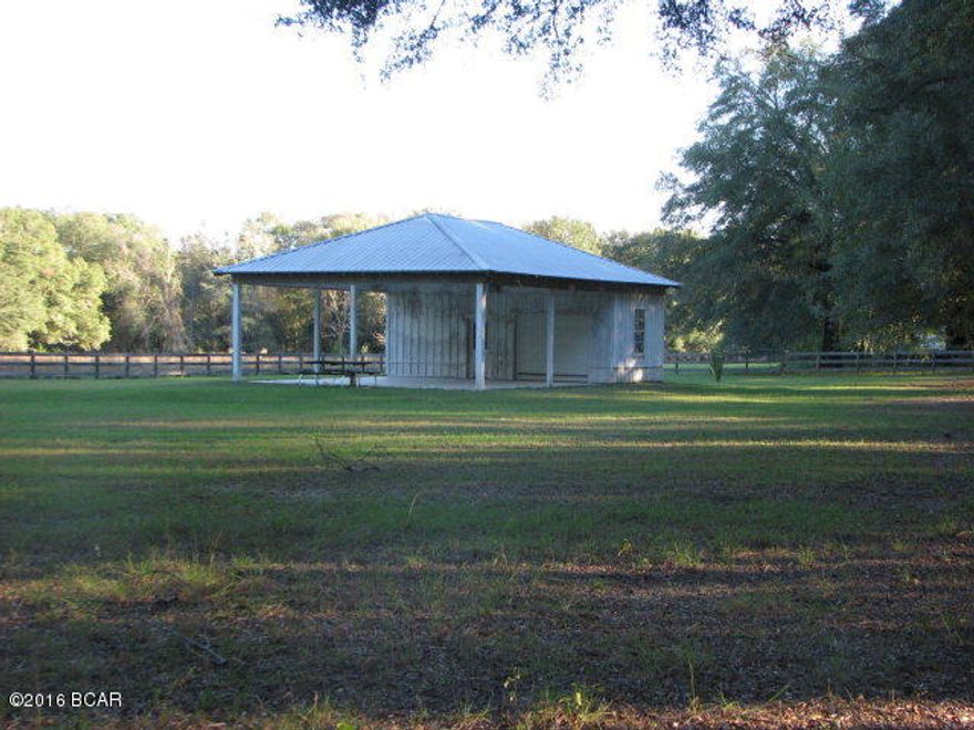 PRICE REDUCED: $29,900 or BEST OFFER! Quiet country living at it best!! It includes wood fencing, big oak trees, fruit trees, garden spot. Deeded easement access to the property. Possibilities for mobile home, home, or just a peaceful get away spot!!! Please make appointment before viewing this property as caretakers live in home at the front of the entrance to the property. This is a beautiful property with underground electric and a completed workshop with a double carport attached. There is not currently a well or septic. Owner had picked out the perfect spot for a dream home!  Possible Owner Financing available.