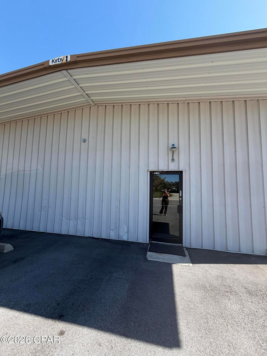 Welcome to your new commercial space in the heart of Panama City Beach, FL. This unique property offers a roll-up door for easy access, making it perfect for businesses that require frequent loading and unloading. The large enclosed area provides ample space for your operations, while the office area is ideal for administrative tasks. Additionally, the upstairs loft area offers extra storage and extra parking lot ensuring you have plenty of room to keep your inventory or supplies organized. This property operates on a triple net lease, Don't miss out on this versatile commercial space in a prime location.