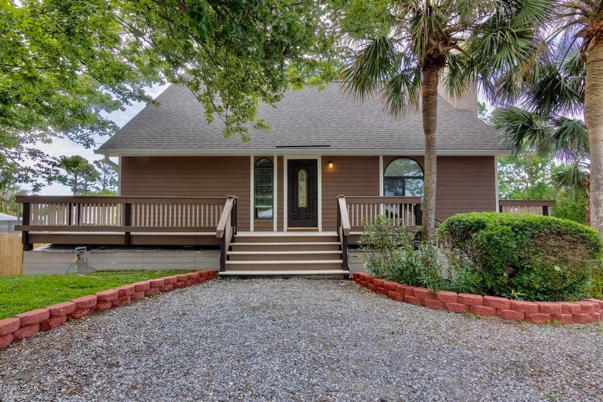 Reward yourself with this beautiful renovated home in the heart of Panama City beach! Centrally located for shopping, dining, entertainment and the white sandy beaches in the desirable Treasure Palms subdivision. This attractive home exudes value with two driveways you'll have plenty of parking for boats, RVS, friends and family. Other highlights include a stocked pond and beautiful sitting area, new paint on the interior and exterior, new luxury vinyl flooring throughout the home, to the ceiling stone fireplace and the vaulted ceilings will have you feeling larger than life. Natural light flows throughout this home with over 1,420 sq.ft of sprawling entertaining spaces you'll enjoy the perfect setting for relaxing and entertaining. The spacious kitchen with access to the large balcony is perfect for cooking up your favorite meals. Both bedrooms provide plenty of comfortable space for sleep, study and storage. Both have private full baths that have been renovated with new counters and fixtures. Keeping convenience in mind the home has a half bathroom for guests. Other highlights include additional storage under the home also large enough to park a small car or golf cart. This affordable home is a must see, you  want to schedule your private showing immediately. Call today to set up your showing.