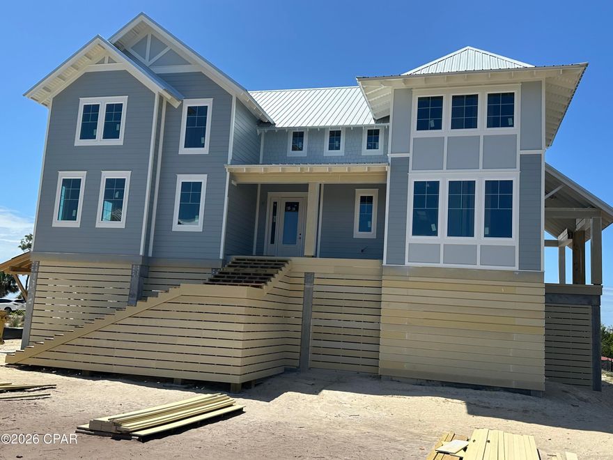 Nestled in the gated community of WindMark Beach, this exceptional new construction home is being built by highly regarded Bonavic Construction. The open floor plan blends refined coastal style with everyday comfort while capturing views on every floor..  The Great Room features a gas fireplace and opens to a wrap-around balcony for seamless indoor-outdoor living. A spacious screened-in 'Sun Room' with a second gas fireplace offers year-round enjoyment, while preserved view corridors showcase sunrise over the Preserve, bay sunsets, and Gulf Coast stargazing.  The home offers four private en-suite bedrooms, a modern kitchen with oversized island,  beverage bar, and a serene Primary Suite with cathedral ceilings and private lounge. The ground level includes a three-car garage with generous storage and elevator access to all floors.  Construction should be complete in July.  Floor plans and a design for a walk-out pool are available.    WindMark Beach provides deeded beach access, a clubhouse, community pool, scenic trails, boardwalks, and a true golf-cart lifestyle—perfect for full-time living, a vacation retreat, or investment.