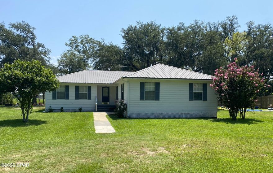 Beautiful well-maintained home on 1 acre on paved state road with 225' frontage. Split floor plan with bonus room adjacent to master suite, suitable for office, nursery, exercise, etc. Ceiling fans in L/R, bonus room, and all 4 bedrooms, three of which have large walk-in closets. Two-inch white faux wood blinds remain on all windows. Large eat-in kitchen with new Bosch stainless steel D/W, Stove & side-by-side refrigerator which remain with home. Nice screened porch off kitchen opens to a deck and covered double carport. Beautiful oak laminate floors throughout, except stone color in kitchen, baths, and large inside laundry room. Total electric, central H/A, private well, septic. 

Quiet country living only 15 minutes to historic Marianna, home of Chipola College, Florida Caverns, and Blue Springs Recreation. Also convenient to numerous metro areas such as Panama City Beach, Tallahassee, Dothan, Alabama, etc. Great fishing and boating locations nearby, including famous Lake Seminole.