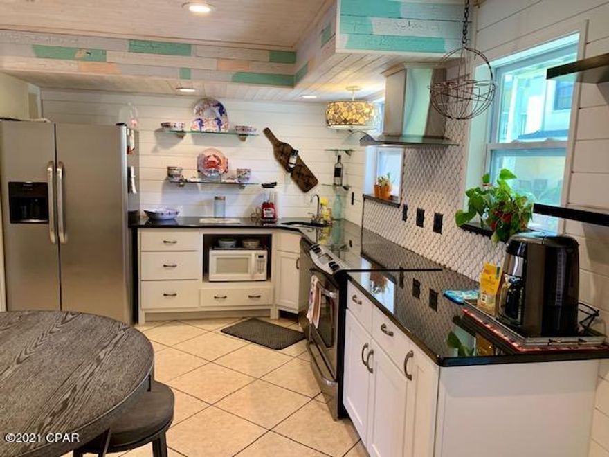 MUST VIEW Pictures!!!!  2 Bd/1.5 Bath town home located across from Heated Pool/Tennis/Shuffle Board courts.  Awesome REMODELED Unit- Creative Open kitchen layout, Custom staircase, bunk bed in guestroom, bathrooms and Laundry room upstairs.   *Gulf Highlands Beach Resort has a Private GULF FRONT Clubhouse with a snack bar and Pool. FREE use of its 11 Pools in total (5 Heated), Tennis & Shuffle Board courts, an 18 Hole Mini-Golf Course, Exercise Room, Playground area, Conference Center with Wi-Fi Connection. Golf Cart parking near the beach, Long and Short Term RENTALS allowed, LOW HOA Dues, Gated Community, Security. As an Owner, you own two parking spaces in front of unit.  This is not a Condo but a fee simple townhome. Age, SF, and dimensions approximate, please verify if important.