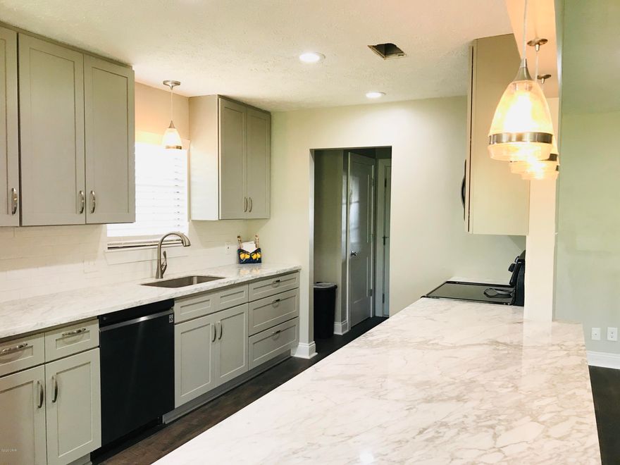 'CURRENTLY UNDER CONTRACT, SELLER ACCEPTING BACKUP OFFERS' Waterfront access to the Bay! This home has a brand new modern kitchen,  luxury plank vinyl throughout kitchen, living, and dining with engineered wood in bedrooms. This kitchen has modern gray cabinets and beautiful granite counter tops with lovely pendant lighting.  You'll love the open floor plan, luxury kitchen and beautiful view to the backyard. The master bedroom has enough space to have sleeping space and a lounge or office space with a walk in closet and modern new bathroom! The additional bedrooms are large and have good closet space.  Lots of new in the home including the roof.  All of this sits on about a half acre with no home owners association. It's centrally located to shopping, doctors and eating.