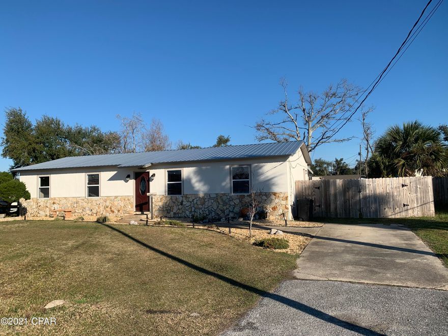 Move-In ready adorable home.  This home features a living room and a family room, vinyl waterproof plank flooring, new paint throughout, recessed lights and metal roof.  You will fall in love with the beautiful natural calico hickory custom kitchen cabinets with soft close drawers, under cabinet lighting and upgraded appliances.  The master bedroom is large enough for a king size bedroom suit. The covered 16x28 back deck has relaxation written all over it.  The home sits on a large .31 acre lot and features two double gates on each side so you can pull your boat or trailer into the back yard.  There is a 12x30 shed with an air compressor for the perfect shop, man cave or she shed.  The exterior faucets and sprinkler system run off the well.  Home comes with a washer and dryer.