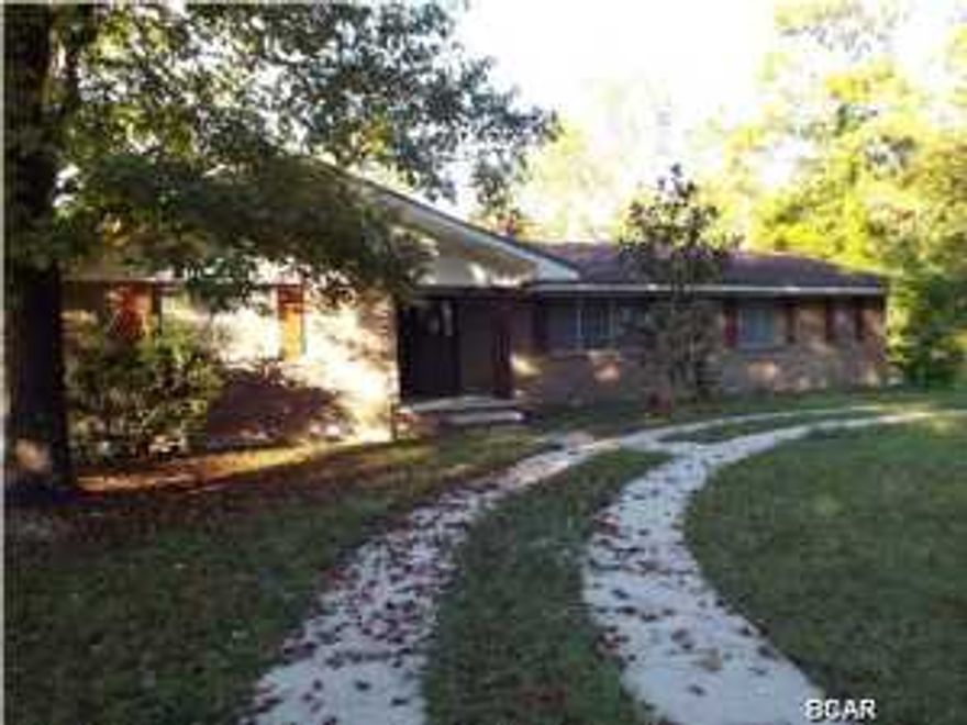 Reduced!!! All brick four bedroom two and half bathroom house needing some TLC, on a two acre lot with water frontage on Laird Bayou and direct water access to the Gulf offered as is. The property has dock for a small boat. There is also another structure that was used as storage and appears to be a convertedgarage. All sizes approximated or taken from other sources please verify accordingly.