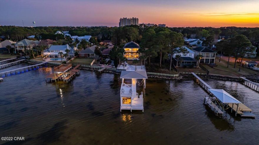 Fully furnished and completely renovated from top to bottom and the home has not been lived in since the renovation. *OPEN WATERFRONT *SALTWATERPOOL *SOLAR PANELS *TWO MASTER SUITES W/ONE ON THE FIRST FLOOR *NO HOA. Welcome to your waterfront retreat located in Miramar Beach! This home has been completely renovated from top to bottom and nothing has gone missed, just bring your suitcase and you are home! When you enter the house, you will be greeted with French doors leading to an open floor plan and a beautiful view of the bay in the distance. As you continue through the home you will find the dining area and the kitchen. The kitchen features wood cabinets with quartz countertops, stainless steel...... appliances with a 6-burner gas range, two wine coolers, floating shelves, a walk-in pantry and an oversized waterfall island with quartz countertops. The kitchen comes fully equipped with everything you need from glasses and silverware to pots and pans. Next you will find the cozy living room that showcases chevron shiplap above the gas burning fireplace and an incredible view of the water. Off of the living room you will find one of two master suites. The first-floor master bedroom features a glass sliding door to the pool and overlooks the bay. The master bathroom features a walk-in closet, toilet room, a double vanity with quartz countertops, a soaking tub with and a white chevron tile accent wall that flows seamlessly into the shower (shower glass has been ordered). On the first floor you will also find a fully updated spare bathroom near the entrance with a floor to ceiling aqua tile backsplash, a new vanity with quartz countertops and beautiful gold accents. The laundry room is located off of the kitchen and comes equipped with a washer and dryer, cabinetry with a countertop for folding clothes and a sink. When you head upstairs you will notice the beautifully designed stair railing that is the perfect contrast to the snowbound walls. There is also a beautiful woven basket chandelier that hangs from the second floor. (The second-floor features two ensuites and two additional good-sized bedrooms with a jack and Jill bathroom). As you reach the top of the stairs you will find the first ensuite that showcases a balcony off of the front of the home with beautiful chevron railing and a large walk-in closet. The bathroom features wood cabinets, quartz countertops, a linen closet and a soaking tub with an aqua tile accent wall.

As you continue down the hall you will find the third bedroom with a walk-in closet and a jack and jill bathroom leading to the fourth bedroom. The bathroom features a shower with black and white floor to ceiling tile and wood vanity with quartz countertops. The fourth bedroom features a private balcony overlooking the bay. Next you will find the second-floor master suite that also features a private balcony with an incredible view of the bay! The master bath features two closets, two vanities with quartz countertops, a toilet room and a beautiful floor to ceiling tile walk in shower. As you head downstairs and step out of the back door you will be blown away with the view and outdoor features this home has to offer. Under the screened lanai you will find the heated saltwater swimming pool with an elevated spa that flows into the pool and is surrounded by pavers. The pool has been recently refinished and showcases aqua accent tiles along the water's edge. You will also find an outdoor shower, outdoor kitchen with a gas grill, ice machine and a sink. As you continue your way to the water's edge you will notice the newly sodded backyard with a fence and sprinkler system (front and back). You will also find your own private beach and a dock leading to the boat lift, sunbathing platform and the fish house. The covered boat slip features an 8,000-pound boat lift that sits on the west side of the dock and there is space for a second lift on the east side. When you reach the end of the dock you will find the screened in fish house with an ice machine, refrigerator, a seating area and a fish cleaning station outside of the door (power and water on the dock). As you walk upstairs to the sundeck you will be impressed with the incredible view. The entire home has been painted with elastomeric paint, has a cement tile roof and the driveway features pavers. There is also a large storage room on the third floor with open cell spray foam insulation.

A few additional features and upgrades: new lighting, new door hardware, new cabinet hardware, new mirrors, new toilets, new luxury vinyl plank flooring, two newer AC units, 7ft baseboard, crown molding throughout, ring security system, nest thermostat All sizes, ages are approximate, please measure and/or verify if important