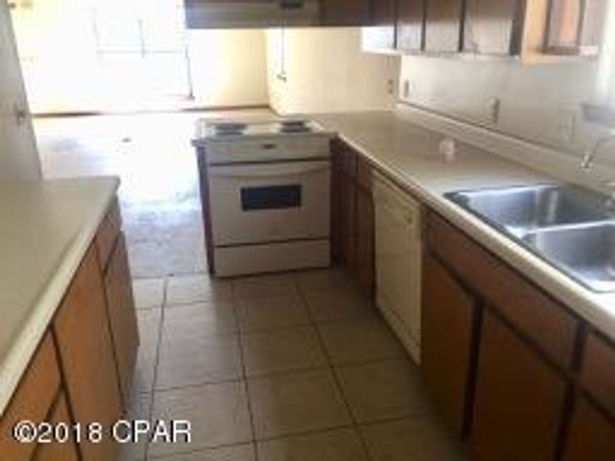 Here's a great opportunity to own an end unit townhome, close to 23rd St and only 20 minutes from Panama City Beach.  This home features a master bedroom & bath upstairs, with an additional loft/living area.  Downstairs is the main living area, kitchen, 2nd bedroom and bath.     The flooring has been removed, so you can start with a clean slate.  Best of all there is a 1 car garage in the rear, accessible via alleyway.