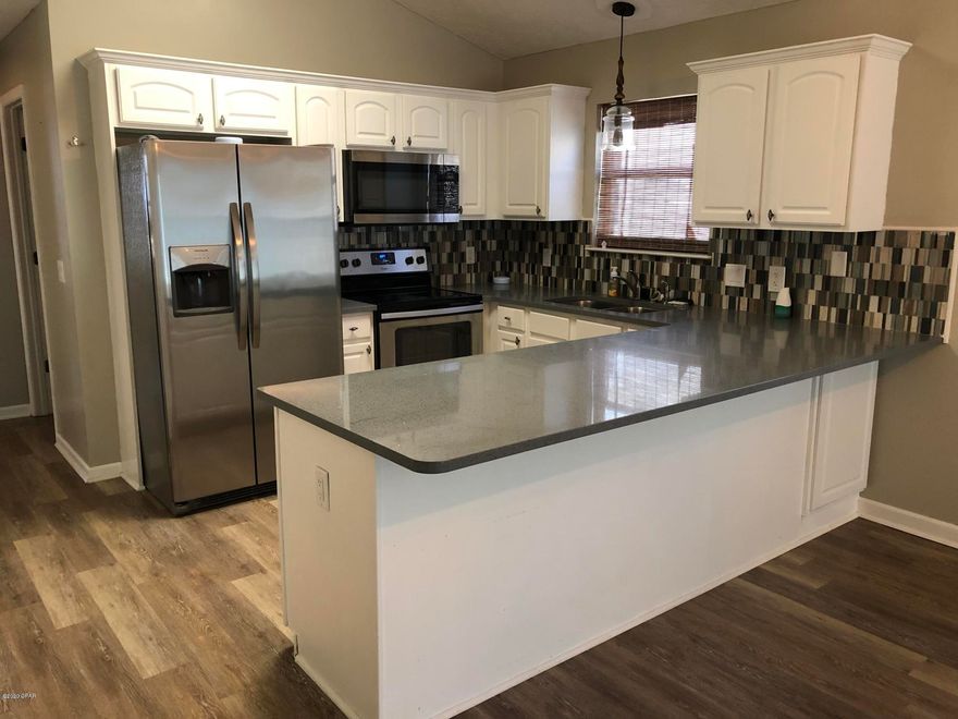 3BD/2BA Home w/1 car Garage in the Palm Cove neighborhood. Gated off of Hutchinson Blvd in Panama City Beach Less than 1 Mile to Public Beach Access with Parking HOA includes: Trash, 2 pools, playground, lawn care and a security guard at night. Remodeled this home offers quartz counter tops, stainless steel appliances, vinyl plank flooring, New carpet in bedrooms, New Wall & Trim Paint inside, pantry, laundry room, and tankless hot water heater. All bathroom and kitchen cabinets have magnetic child proof locks that can be turned on or off. Master Bath double vanity and walk-in closet. Fenced backyard with astro turf. Short Term Rentals Allowed