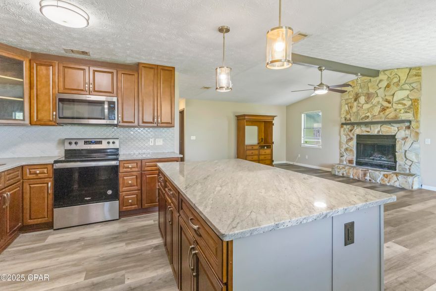 Assumable 3% loan! Beautifully updated 3 bed, 2 bath home on a large corner lot. Upon entering, you are greeted with cathedral ceiling in the living room to open up the space highlighted by a wood burning fireplace. The kitchen features stainless steel appliances, granite countertops, updated cabinets, and large island with bar seating. The large primary bedroom is accommodated with an ensuite bathroom. The guest bedrooms are also spacious with a full guest bathroom conveniently located right outside the doors. The one car garage is big enough to fit your vehicle as well as room for a workshop desk or storage. The laundry room is extensive which can be used for folding tables and additional storage. The fully fenced in back yard with beautiful trees gives you privacy to enjoy the outdoors.